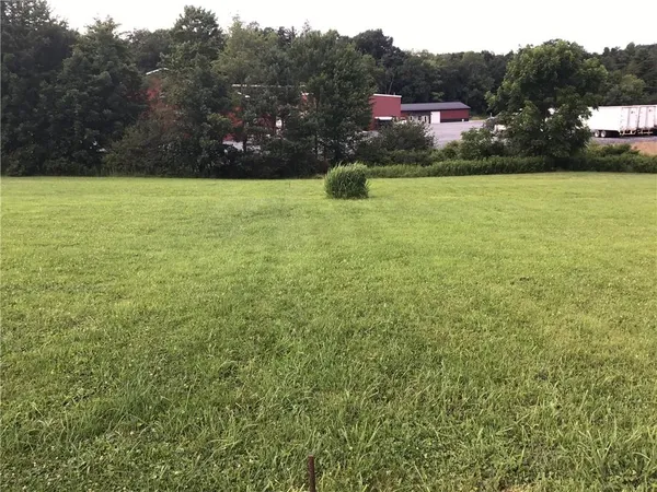 a view of a field with an ocean