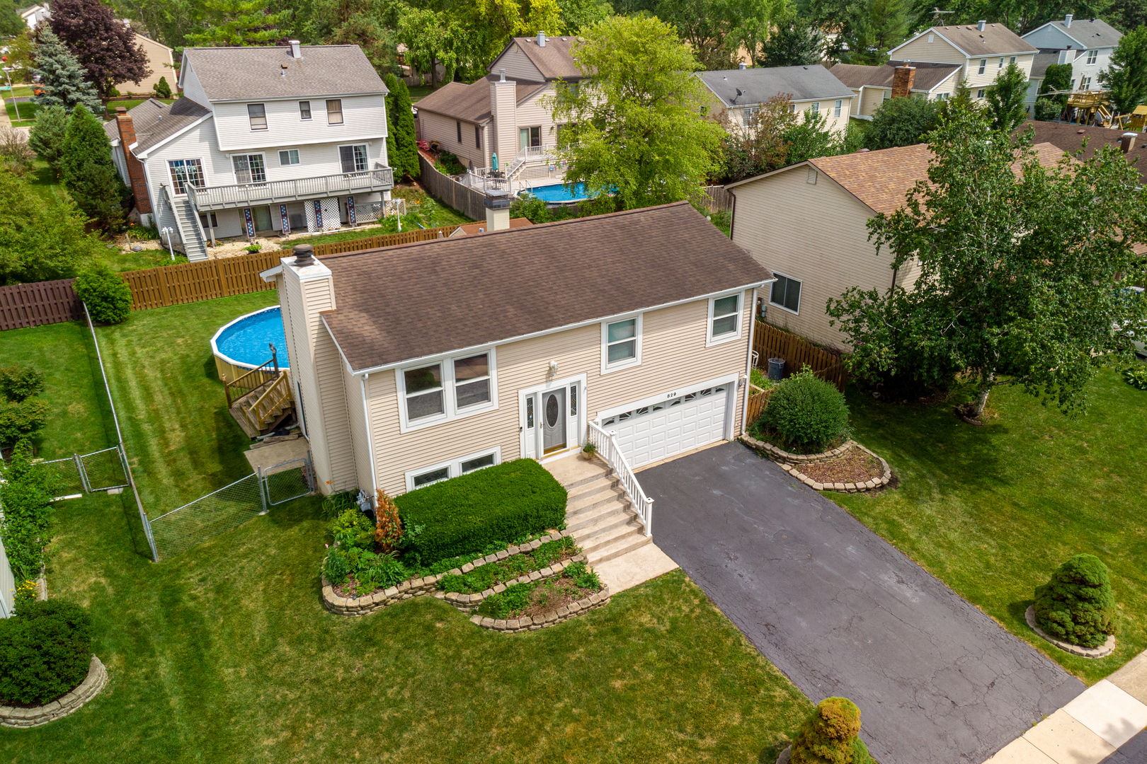an aerial view of a house with yard