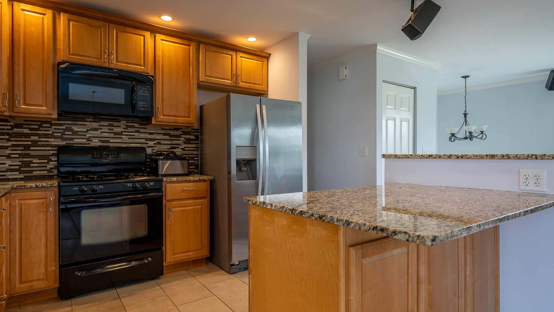 829 Prairie Avenue Bartlett, IL 60103 - Photo 15 of 25 a kitchen with stainless steel appliances granite countertop a stove microwave and refrigerator