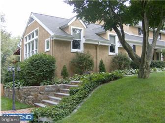 157 Ridgefield Road Newtown Square, PA 19073 - Photo 1 of 12 a view of a white house next to a yard with big trees