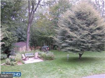 157 Ridgefield Road Newtown Square, PA 19073 - Photo 11 of 12 a backyard with table and chairs and potted plants