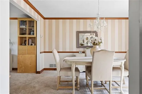 a view of a dining room with furniture and window