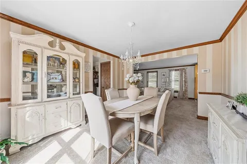 a view of a dining room with furniture and a window