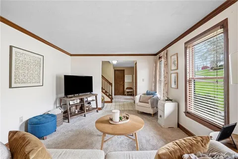 a view of a hallway with a livingroom and couch