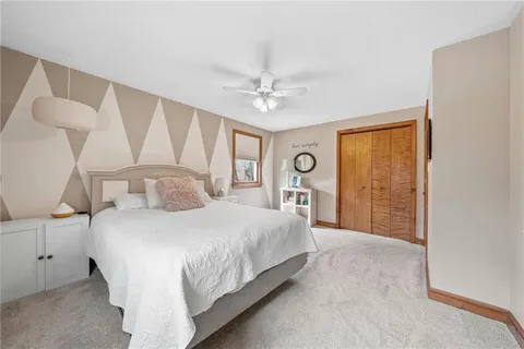 a bedroom with a large bed and a chandelier