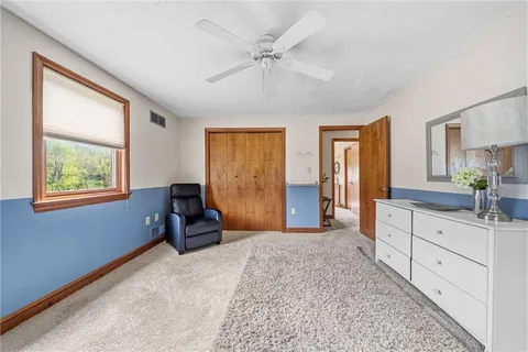 a bedroom with furniture and a window