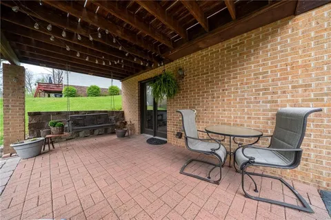 a view of a deck with table and chairs and wooden floor