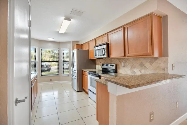 a kitchen with a refrigerator a sink and cabinets