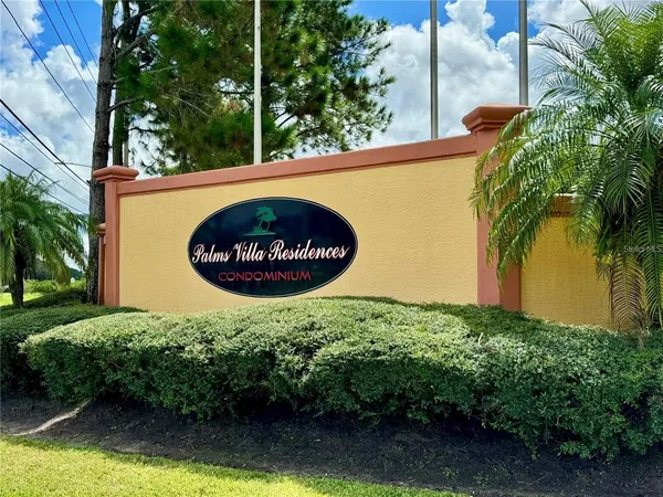 a sign that is sitting on a brick wall