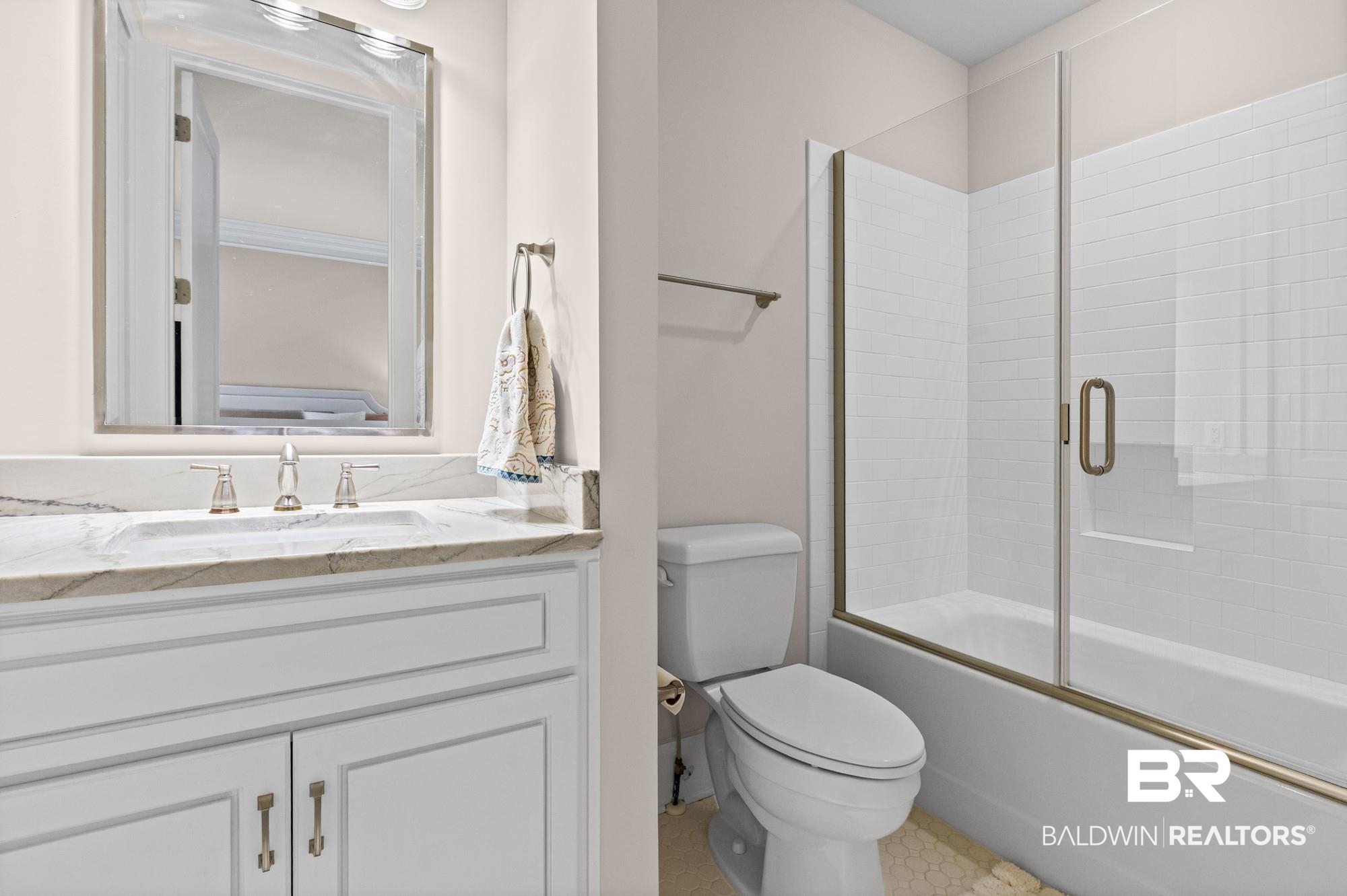 701 Dauphin Street, Unit A Mobile, AL 36602 - Photo 20 of 31 Bathroom featuring a vanity with a stone countertop, an undermount sink, and a framed mirror