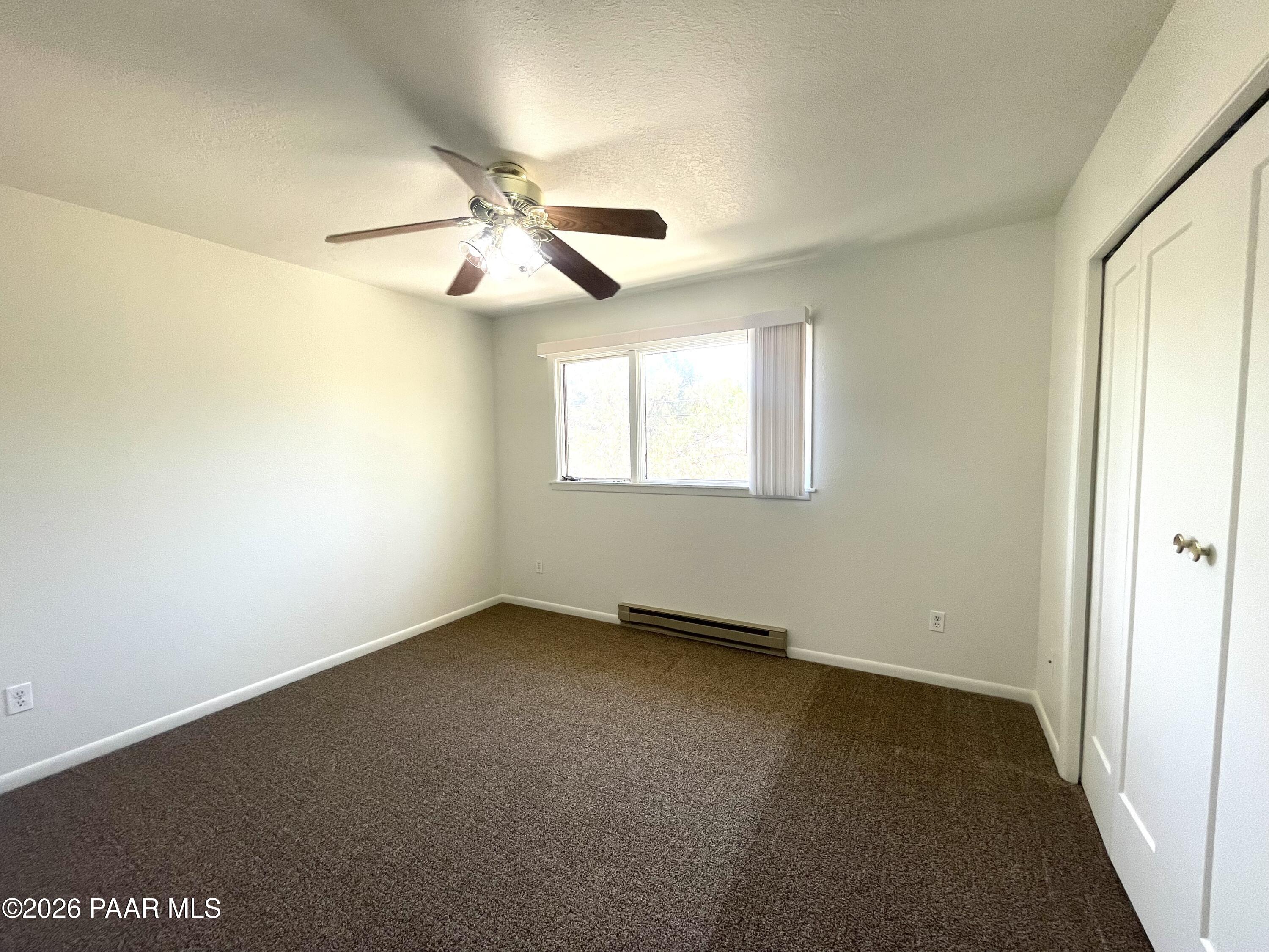 1230 Stetson Road, Unit 10 Prescott, AZ 86303 - Photo 9 of 11 an empty room with windows and fan