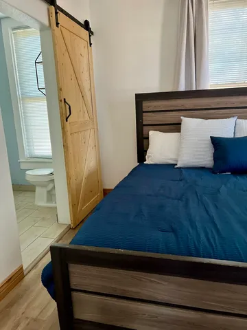 a bathroom with a shower a mirror and a sink