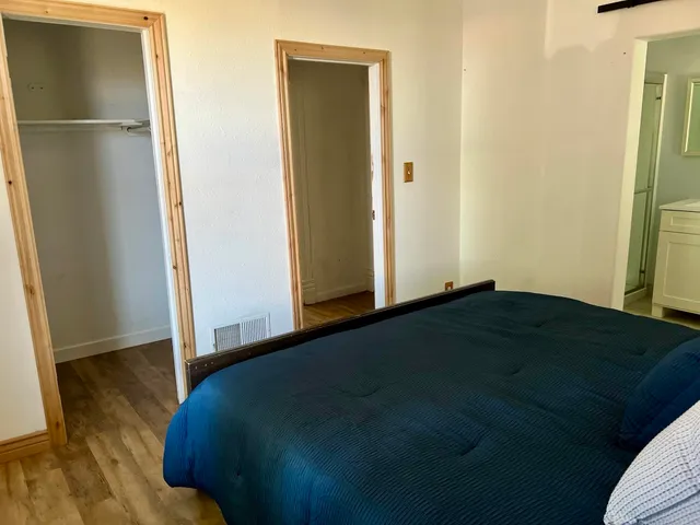 a bedroom with a bed and a window