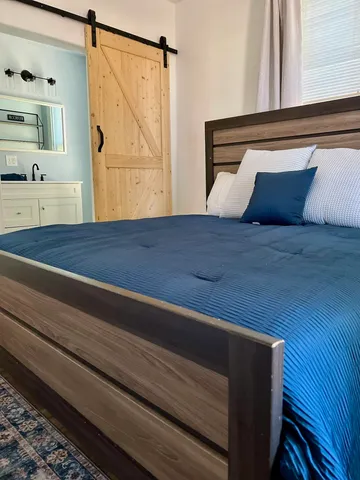 a bedroom with a bed and a window