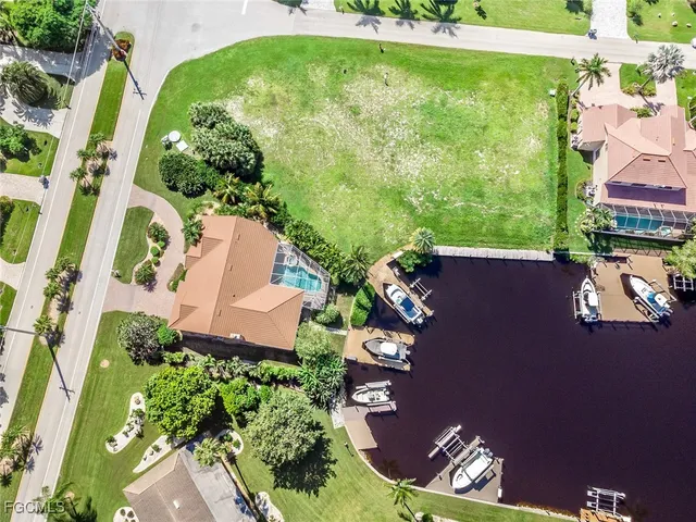 an aerial view of a residential houses with yard