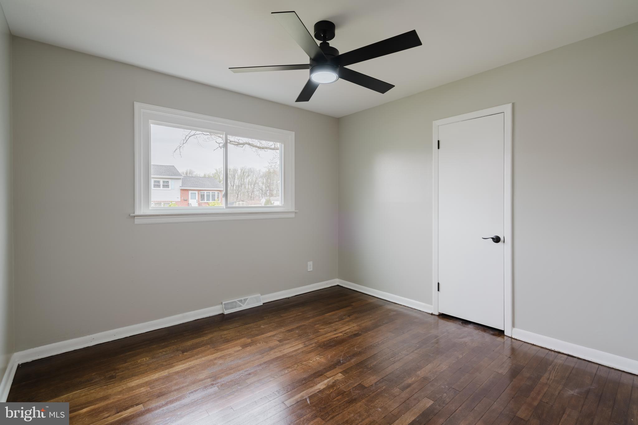 103 Durso Drive Newark, DE 19711 - Photo 17 of 21 a view of empty room with wooden floor and fan