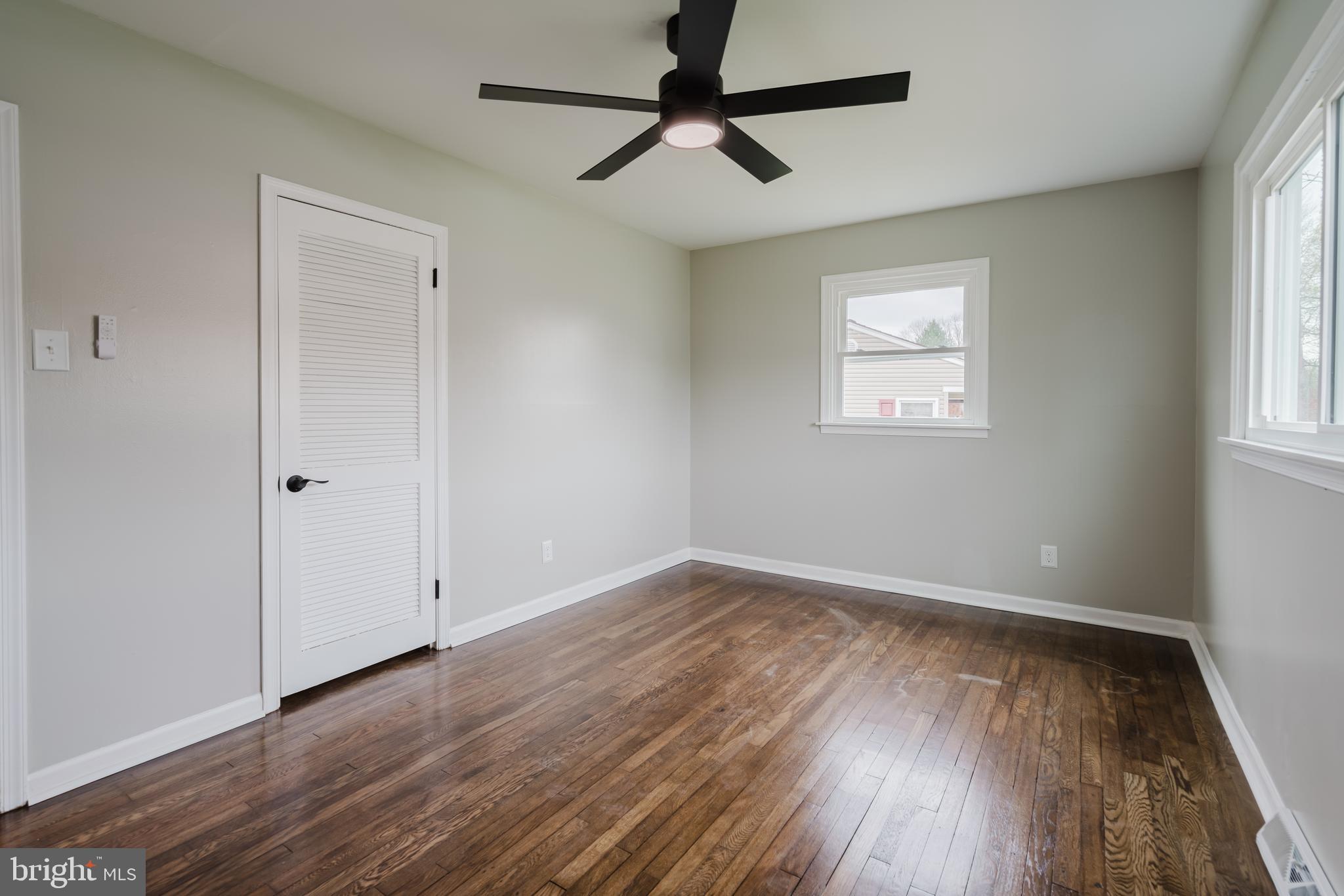 103 Durso Drive Newark, DE 19711 - Photo 20 of 21 an empty room with wooden floor ceiling fan and windows