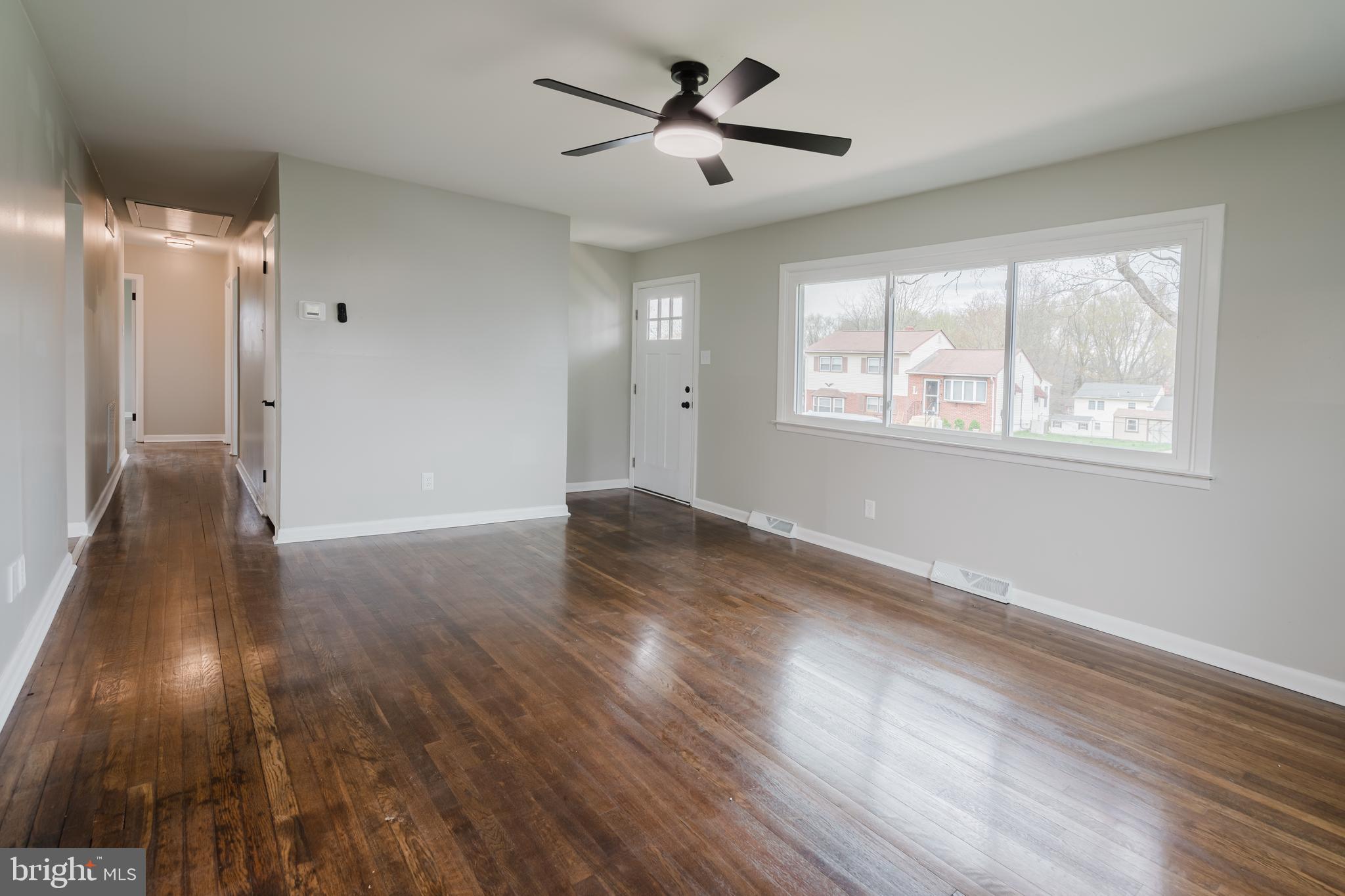 103 Durso Drive Newark, DE 19711 - Photo 4 of 21 a view of empty room with wooden floor and fan
