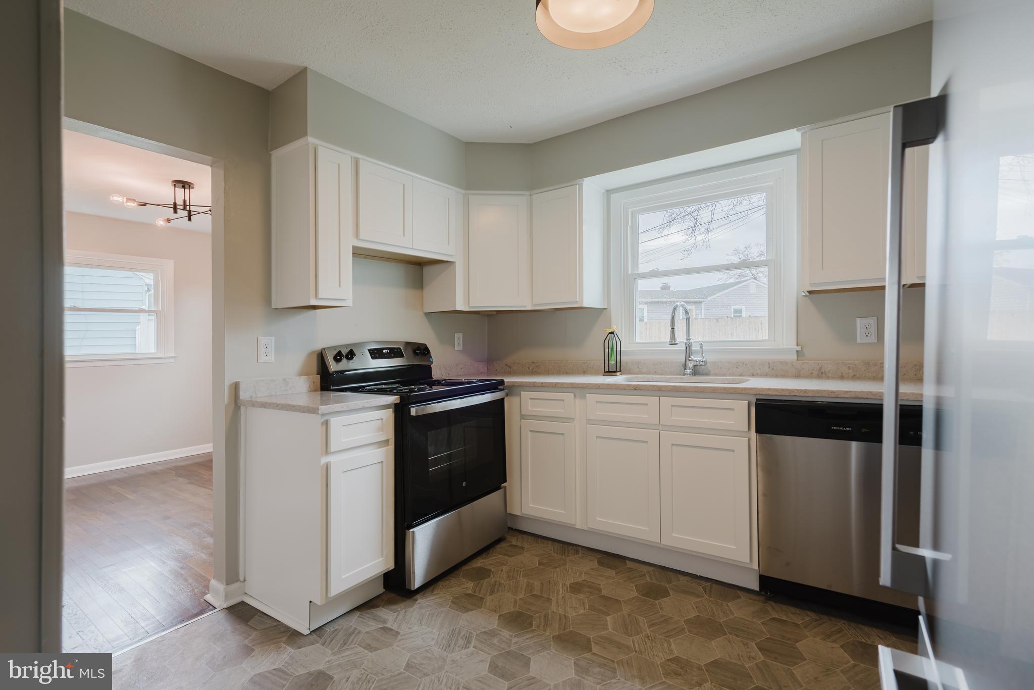 103 Durso Drive Newark, DE 19711 - Photo 7 of 21 a kitchen with granite countertop white cabinets and white appliances