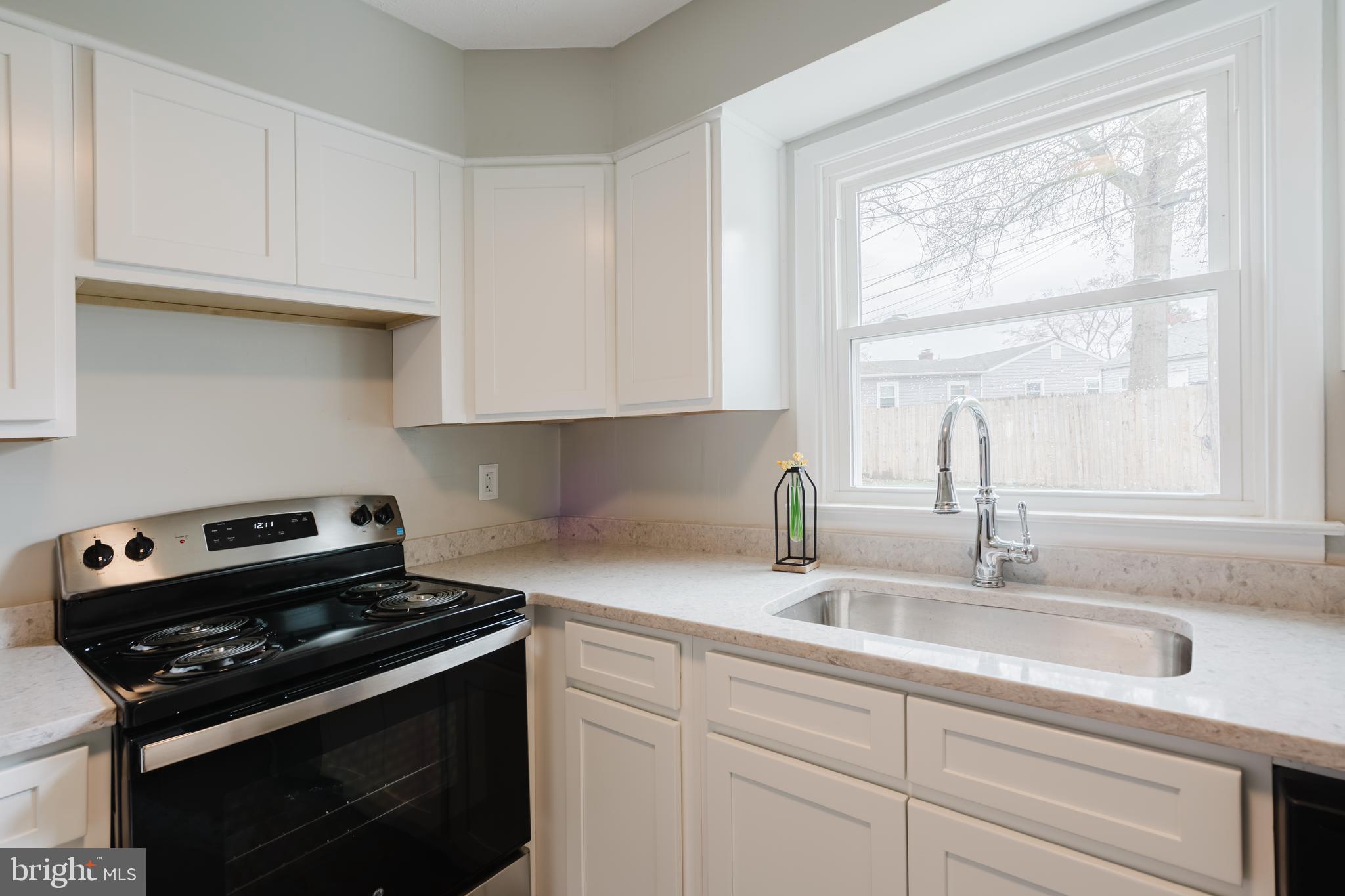 103 Durso Drive Newark, DE 19711 - Photo 8 of 21 a kitchen with granite countertop a sink stove and cabinets