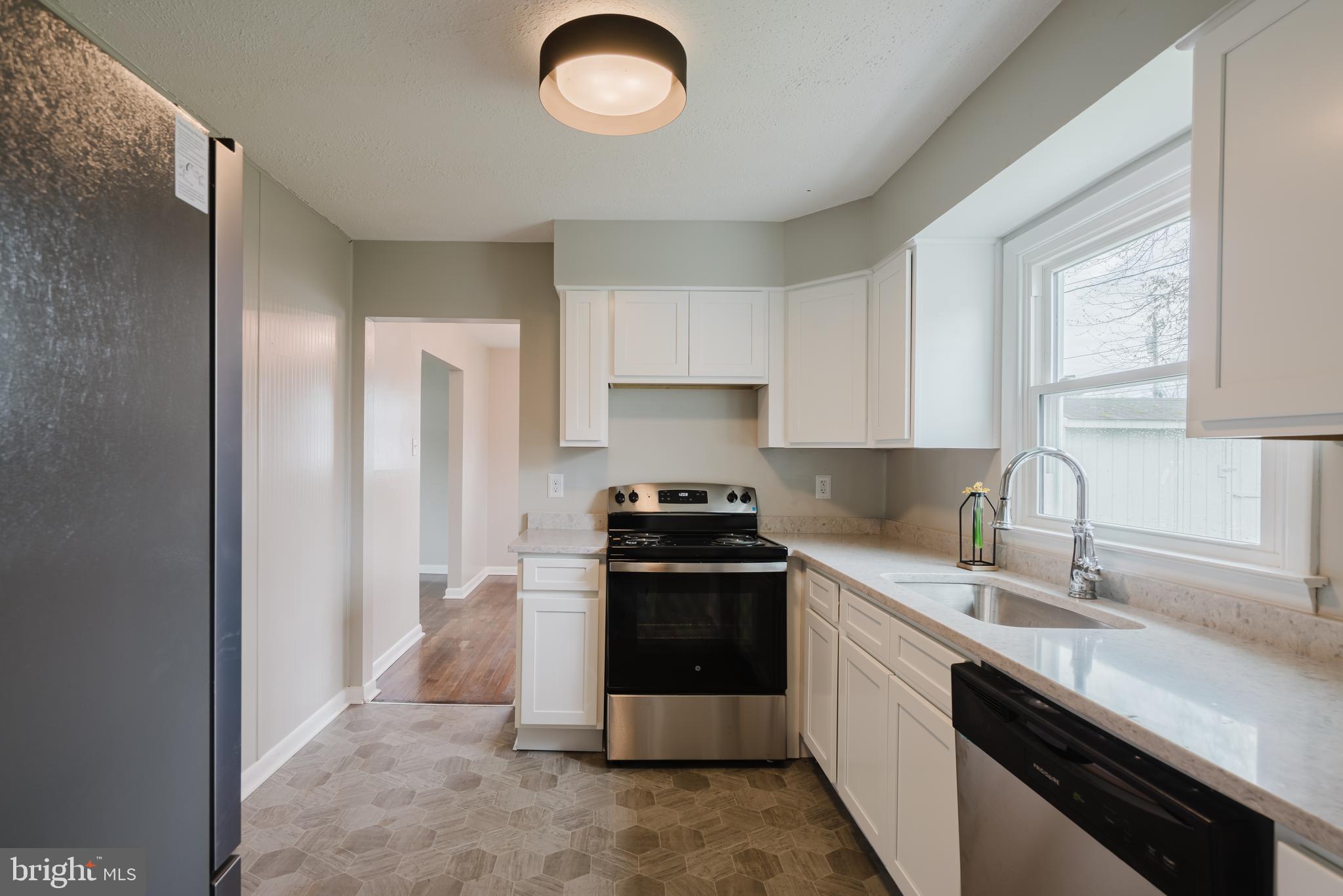 103 Durso Drive Newark, DE 19711 - Photo 9 of 21 a kitchen with a stove sink and cabinets