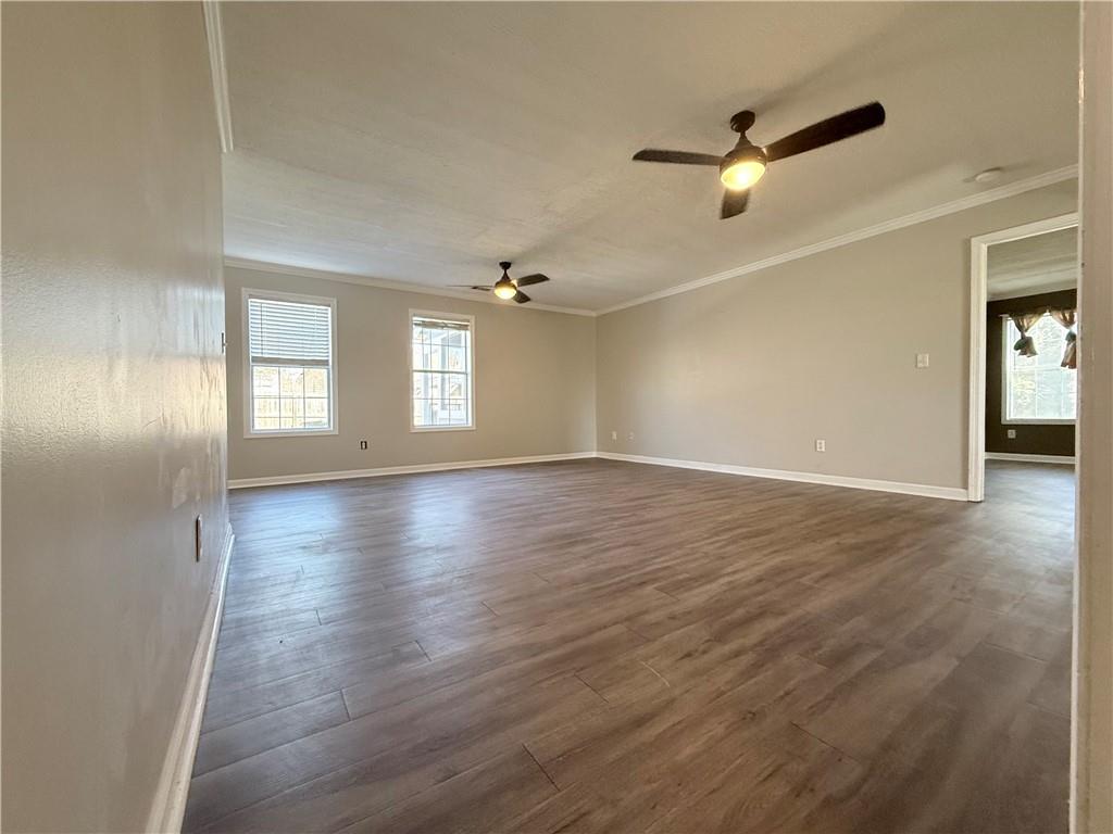 2000 Sage Court Loganville, GA 30052 - Photo 11 of 77 an empty room with wooden floor fan and windows