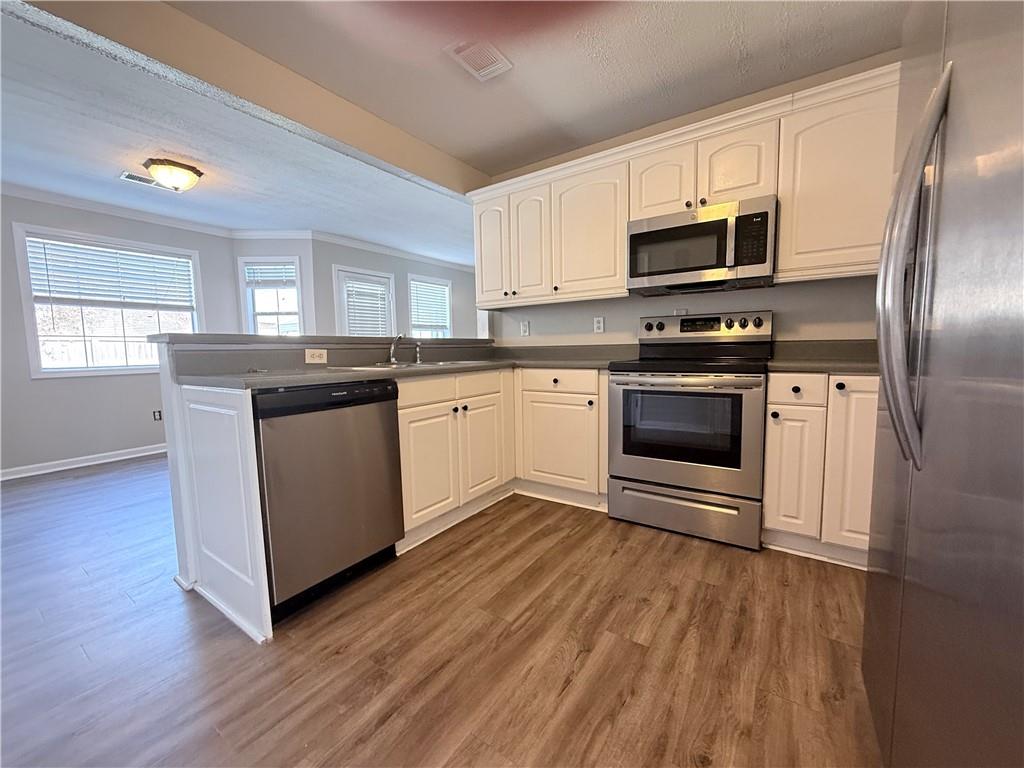 2000 Sage Court Loganville, GA 30052 - Photo 18 of 77 a kitchen with stainless steel appliances granite countertop a stove a sink and a microwave