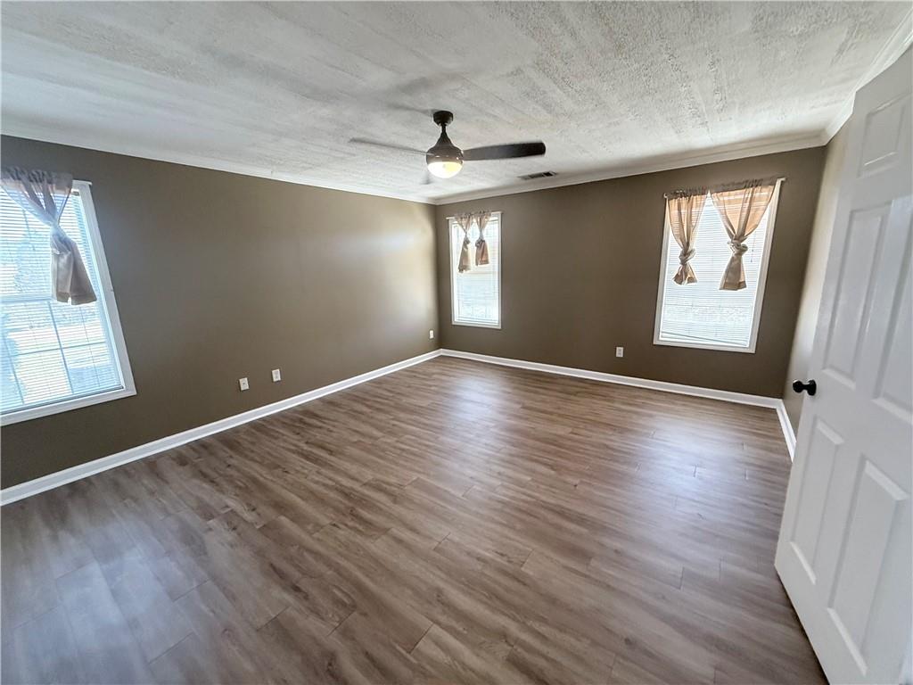2000 Sage Court Loganville, GA 30052 - Photo 23 of 77 an empty room with wooden floor and windows