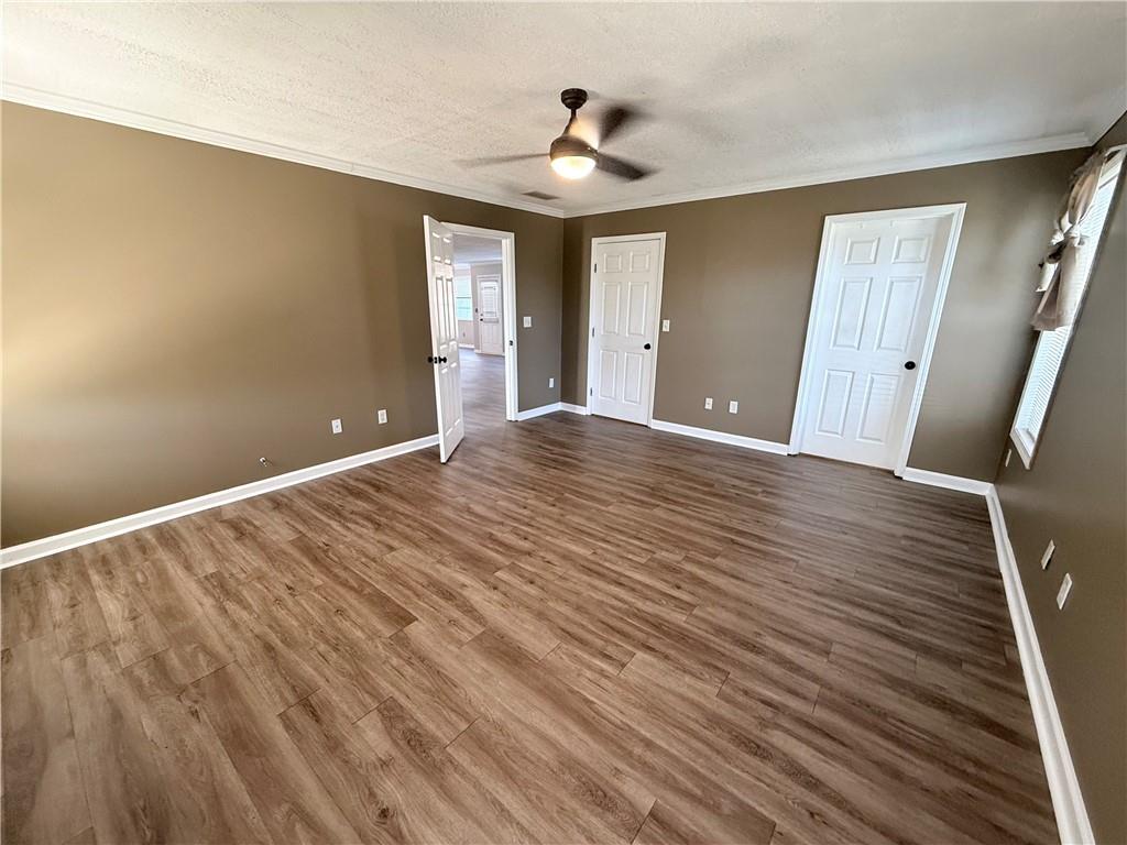 2000 Sage Court Loganville, GA 30052 - Photo 24 of 77 a view of an empty room with wooden floor and a window