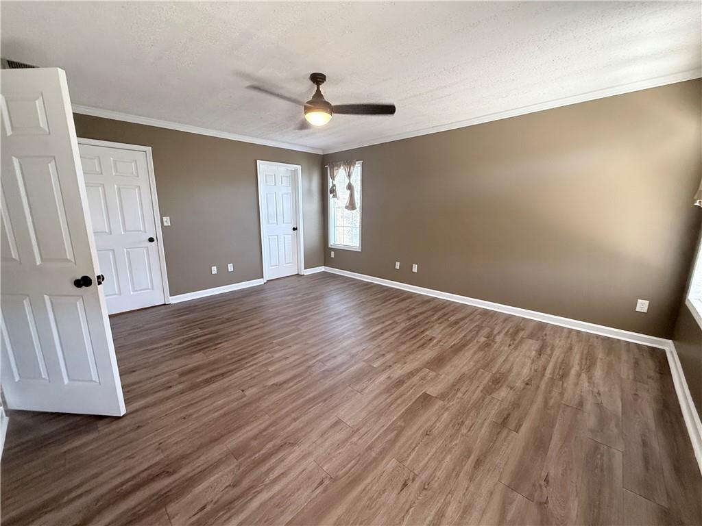 2000 Sage Court Loganville, GA 30052 - Photo 25 of 77 a view of an empty room with wooden floor and a ceiling fan
