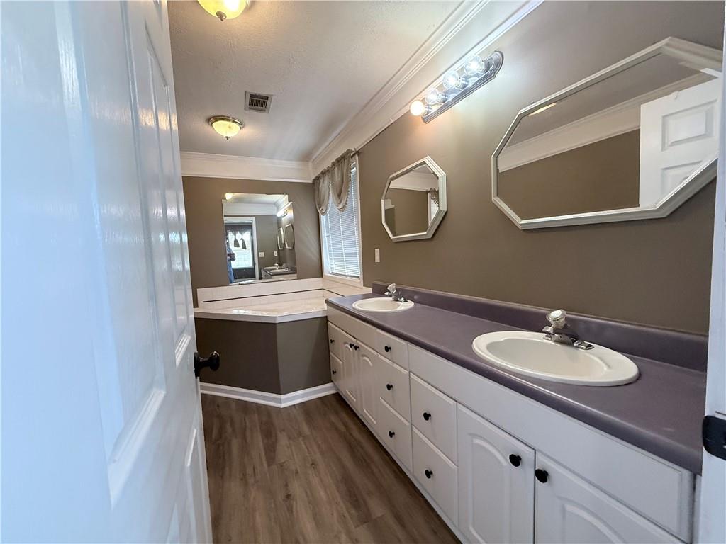2000 Sage Court Loganville, GA 30052 - Photo 27 of 77 a bathroom with a double vanity sink and a mirror