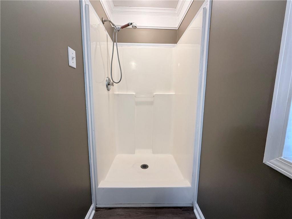 2000 Sage Court Loganville, GA 30052 - Photo 30 of 77 a bathroom with a glass shower door