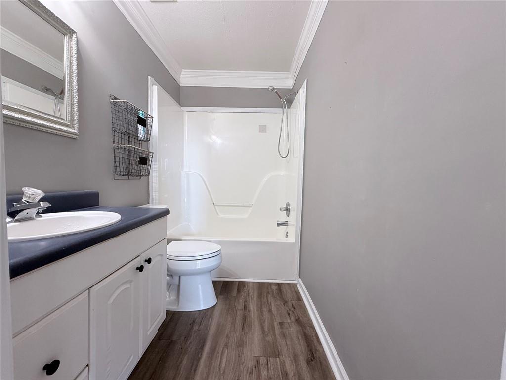 2000 Sage Court Loganville, GA 30052 - Photo 36 of 77 a bathroom with a granite countertop toilet a sink and a mirror