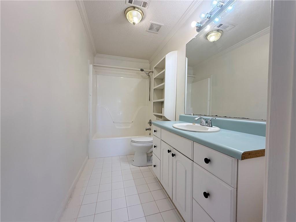 2000 Sage Court Loganville, GA 30052 - Photo 52 of 77 a bathroom with a sink a toilet and mirror