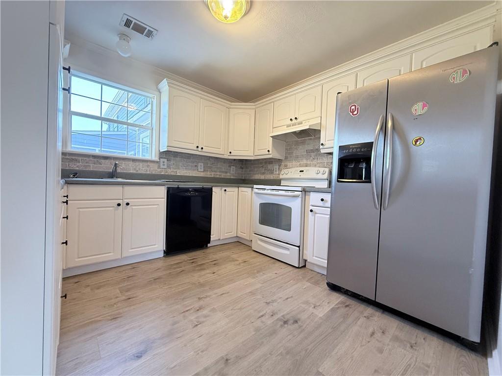 2000 Sage Court Loganville, GA 30052 - Photo 53 of 77 a kitchen with stainless steel appliances granite countertop a stove sink and refrigerator
