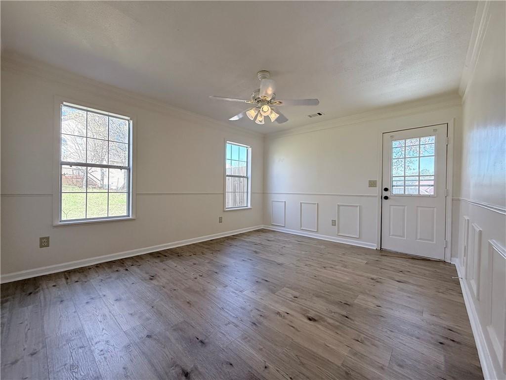 2000 Sage Court Loganville, GA 30052 - Photo 56 of 77 an empty room with wooden floor chandelier fan and windows