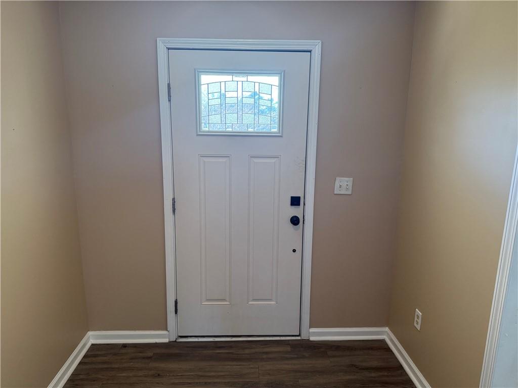 2000 Sage Court Loganville, GA 30052 - Photo 8 of 77 a view of an empty room with wooden floor and a window
