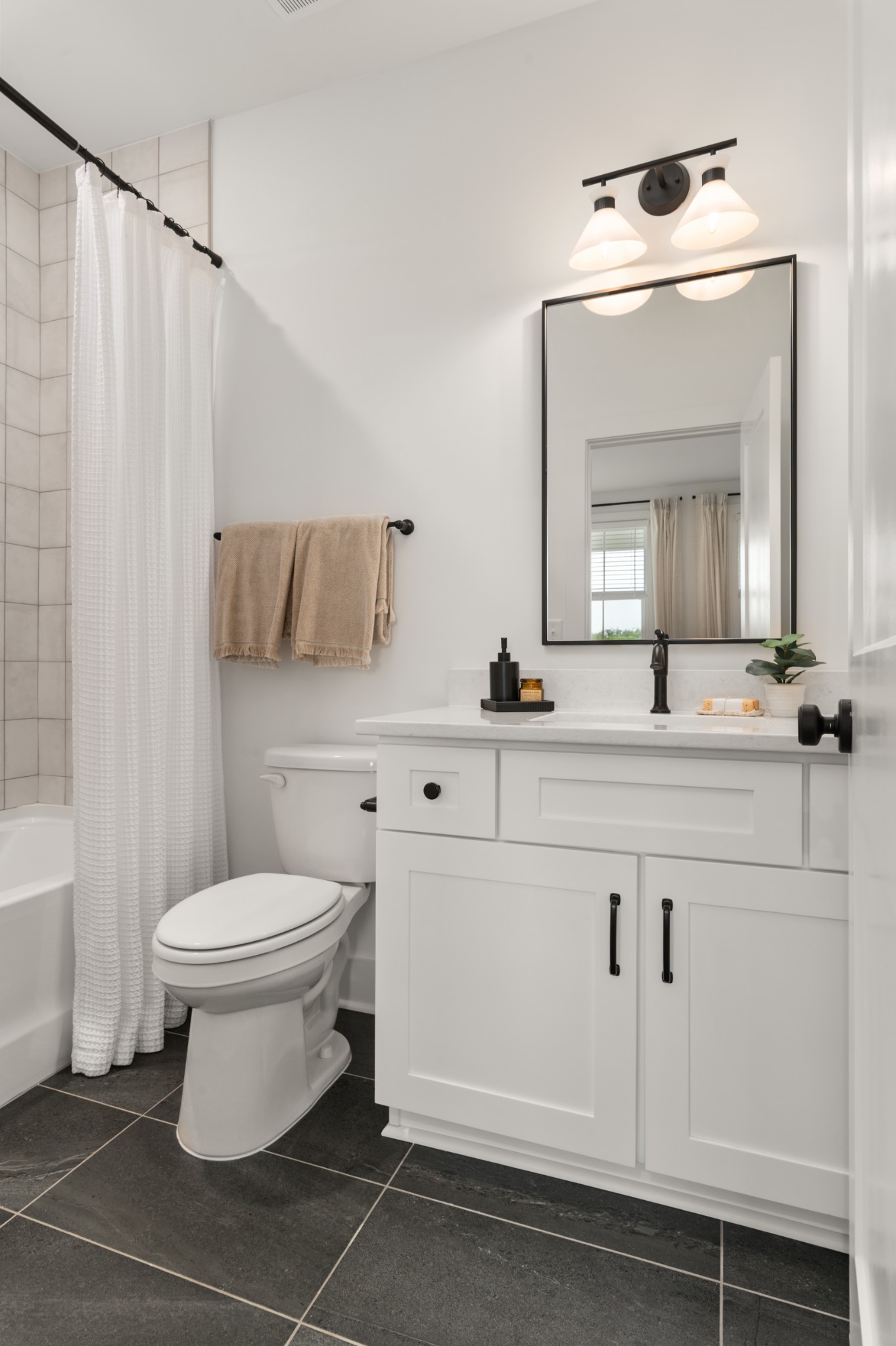 322 Mulberry Terrace, Unit A Madison, TN 37115 - Photo 29 of 33 a bathroom with a toilet sink and mirror