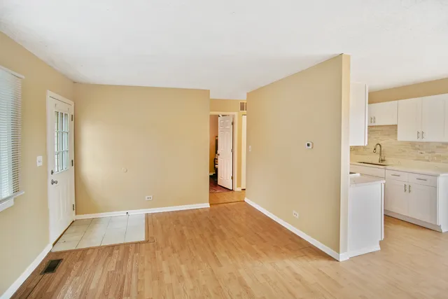 a view of a kitchen with wooden floor and a sink