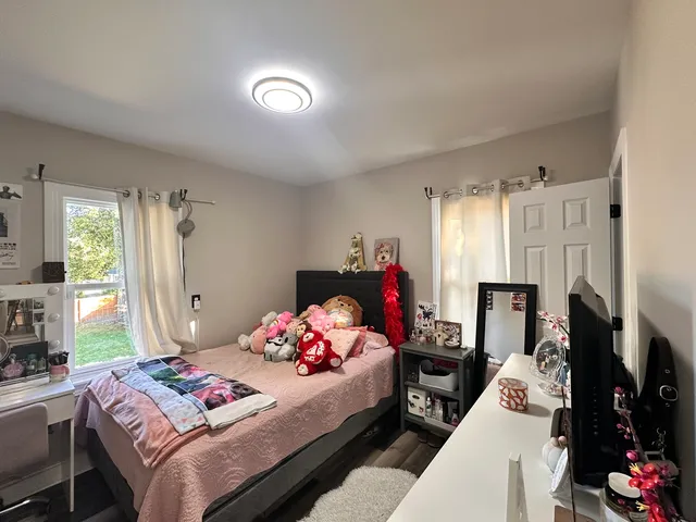 a bedroom with furniture a flat screen tv and a bed