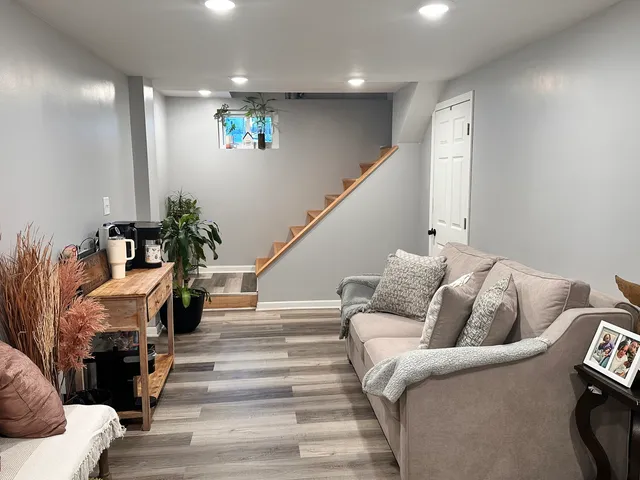 a living room with furniture and stairs