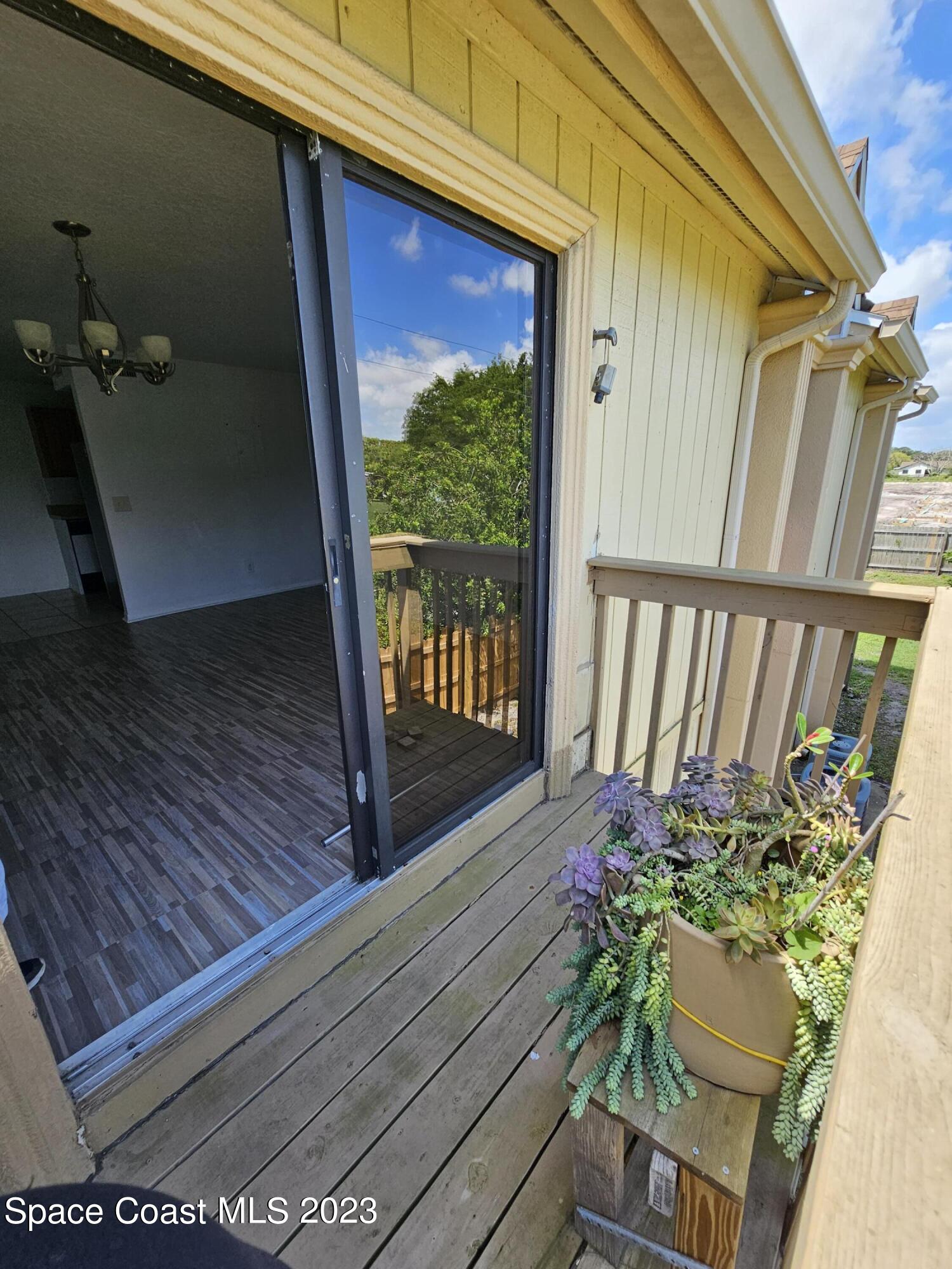 a view of a porch with wooden floor