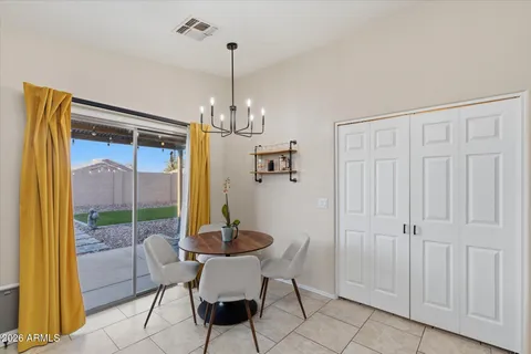 a view of a dining room with furniture wooden floor and a chandelier