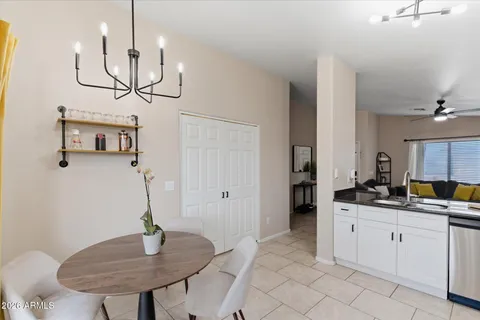 a kitchen with a sink a refrigerator and chandelier