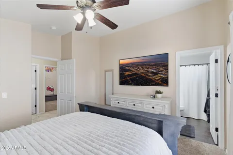 a bedroom with a bed and a flat tv screen in it