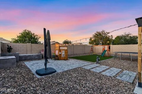 a view of a backyard with wooden fence
