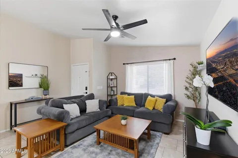 a living room with furniture and a potted plant