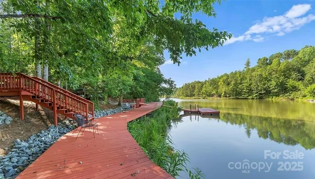 a view of a lake with a floor to ceiling window and a lake view