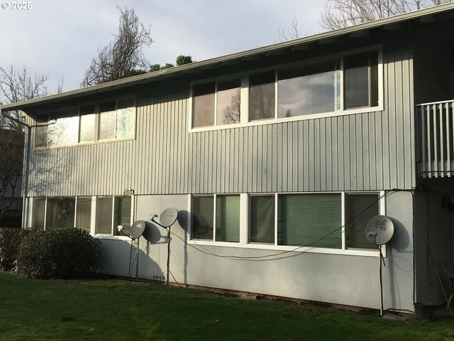 a view of house with backyard