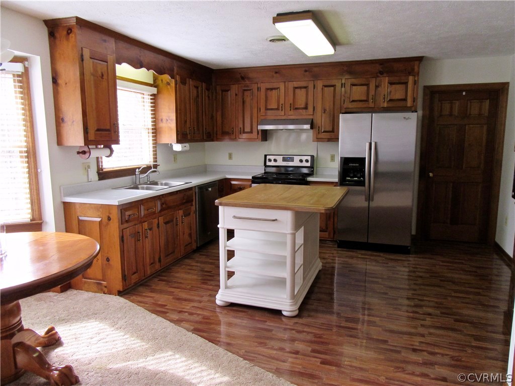 Large Eat-in Kitchen boasts Wood Laminate Flooring
